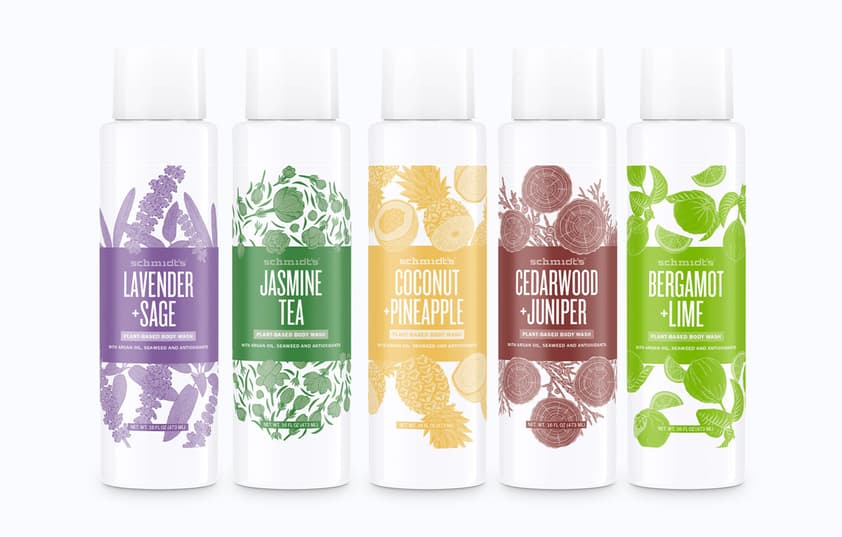 A mockup of various scented body wash bottles stacked next to each other.