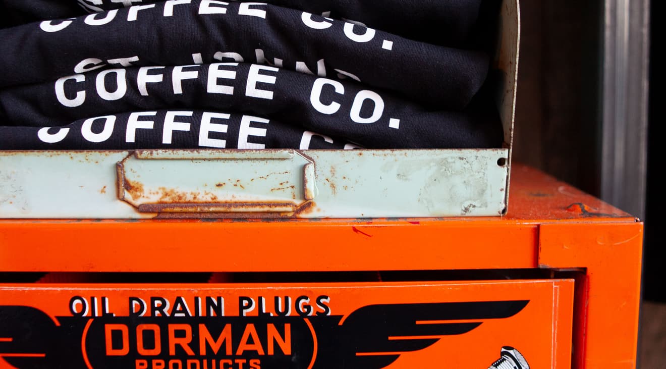 Stack of shirts on top of an old toolbox.