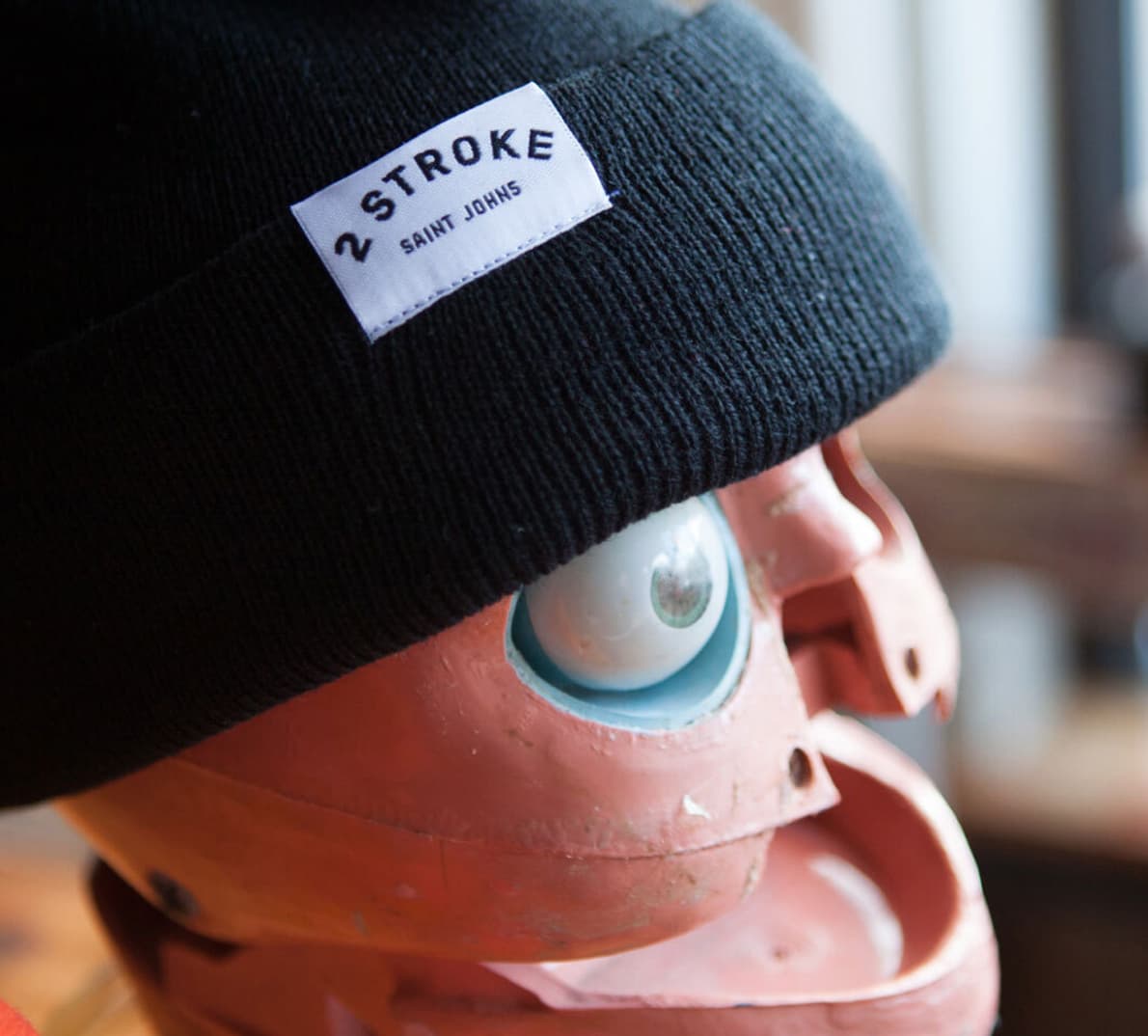 A Two Stroke beanie on a mannequin head.
