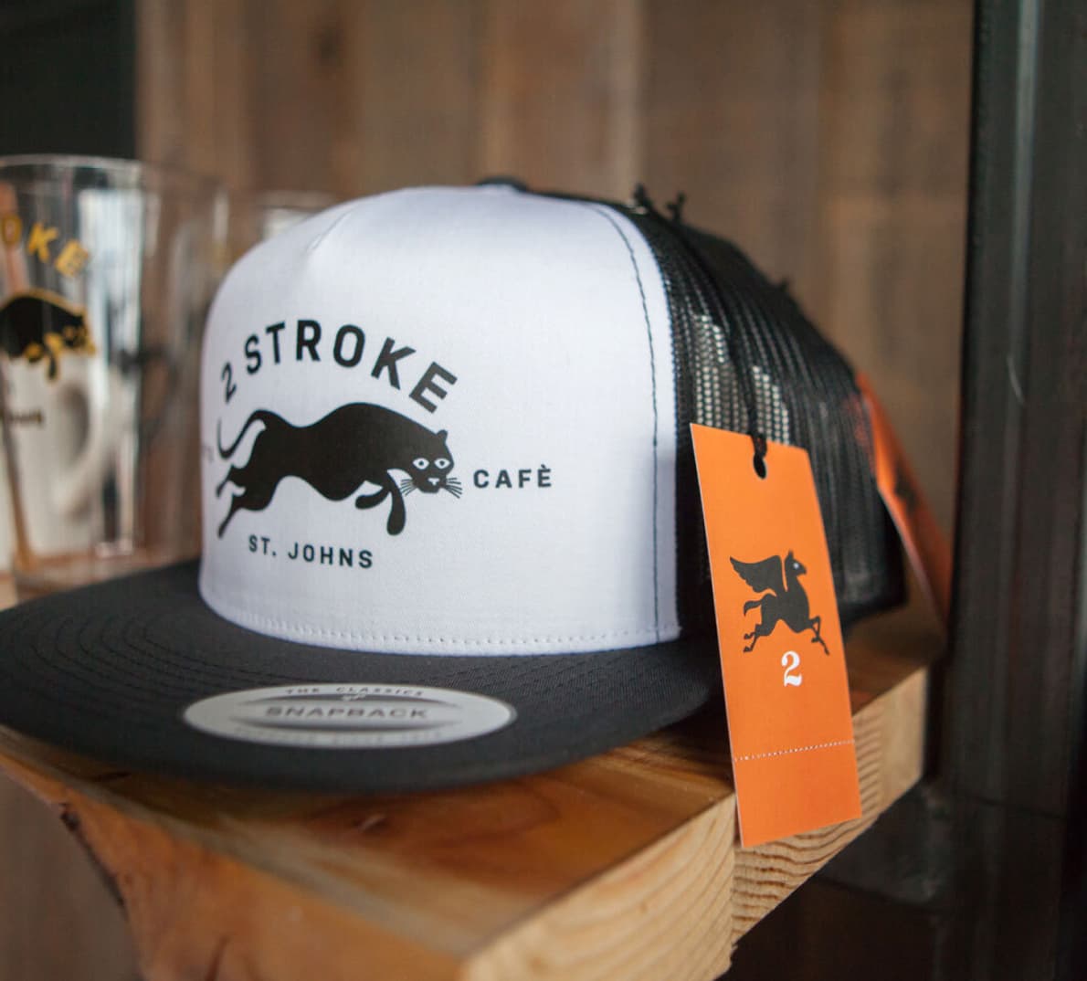 A trucker hat with the Two Stroke logo.