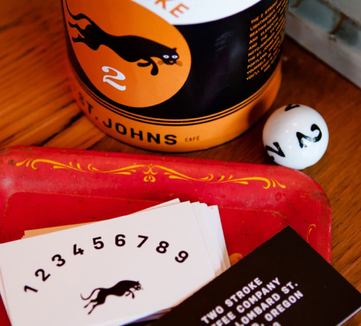 A zoomed-in shot of a coffee can next to some frequent shopper cards.