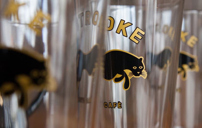 A close-up of pint glasses with the Two Stroke logo on them.