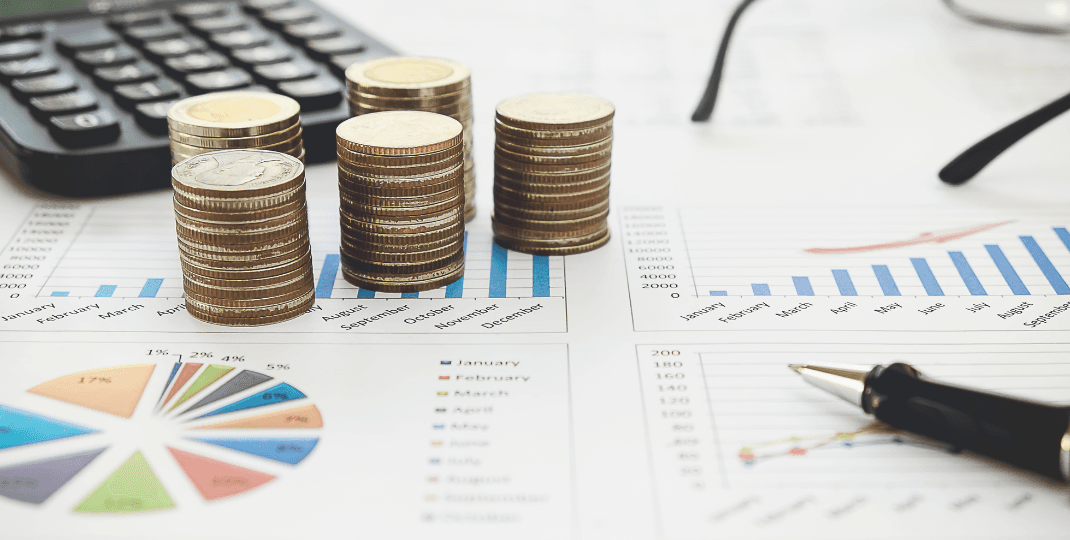 A stack of coins on top of papers