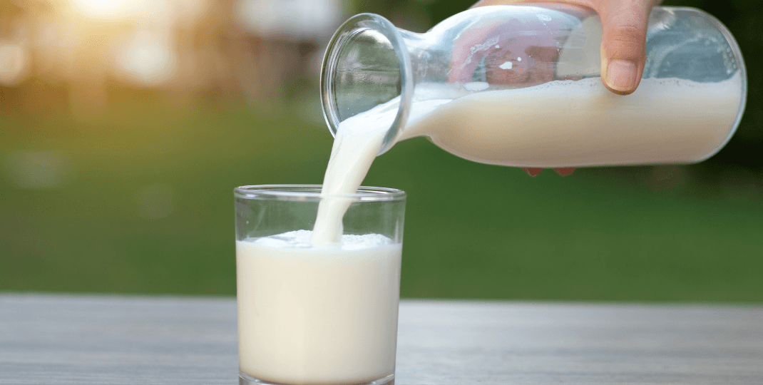 Pouring milk into a glass from a jug