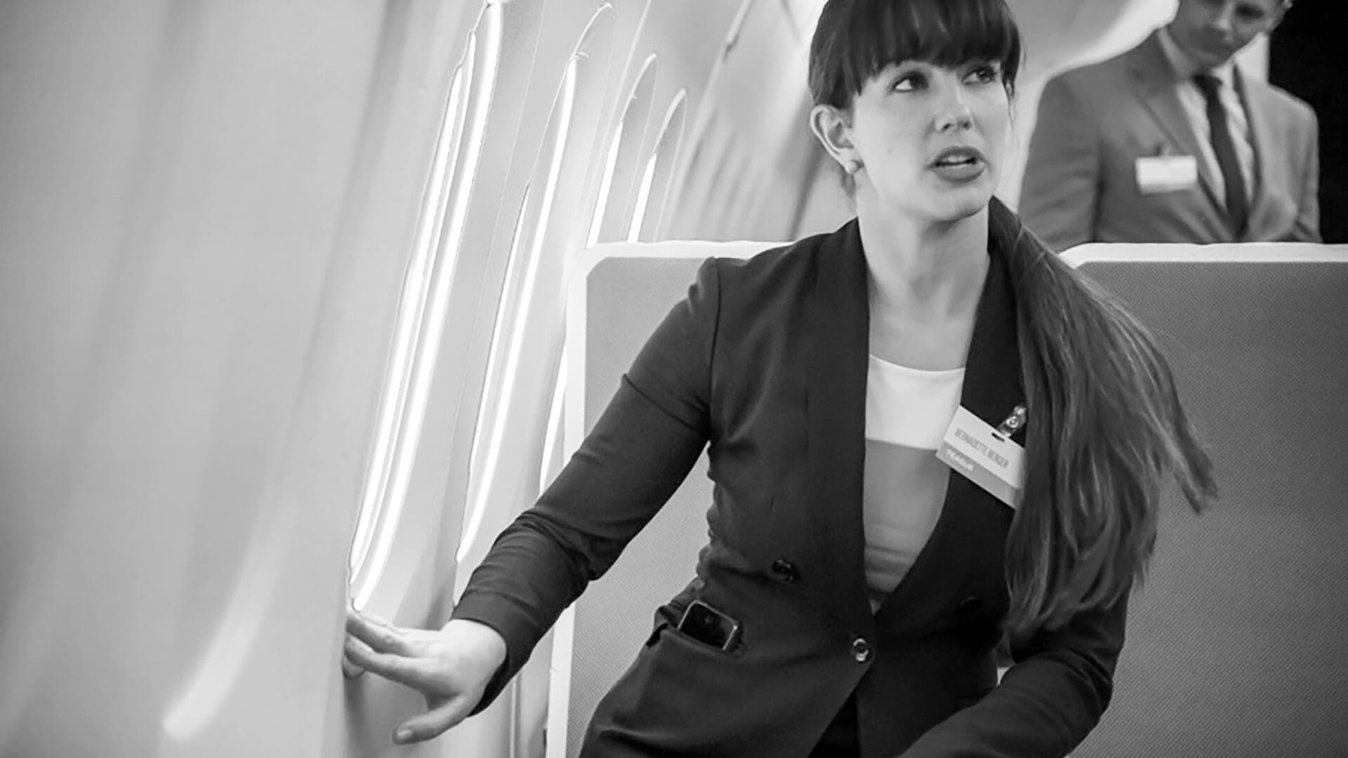 Women sitting in airplane seat touching airplane window