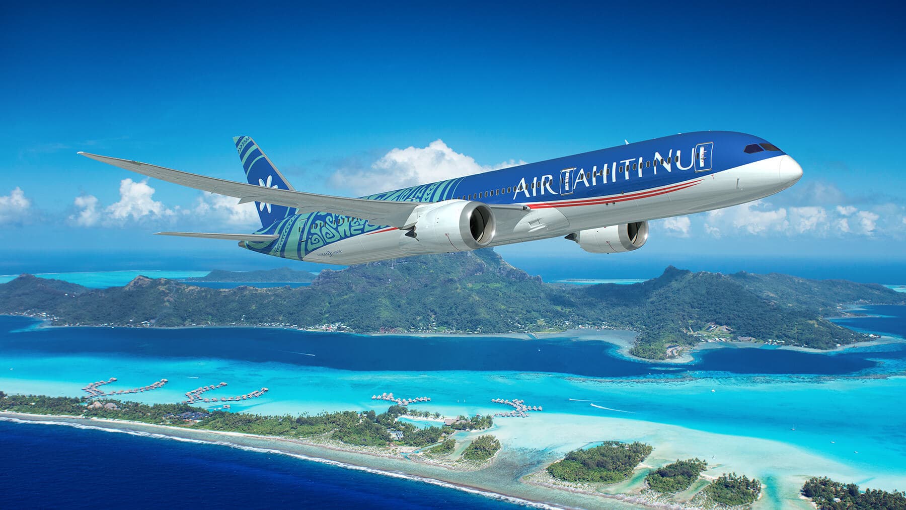 Air Tahiti Nui 787 flying over brilliant blue water
