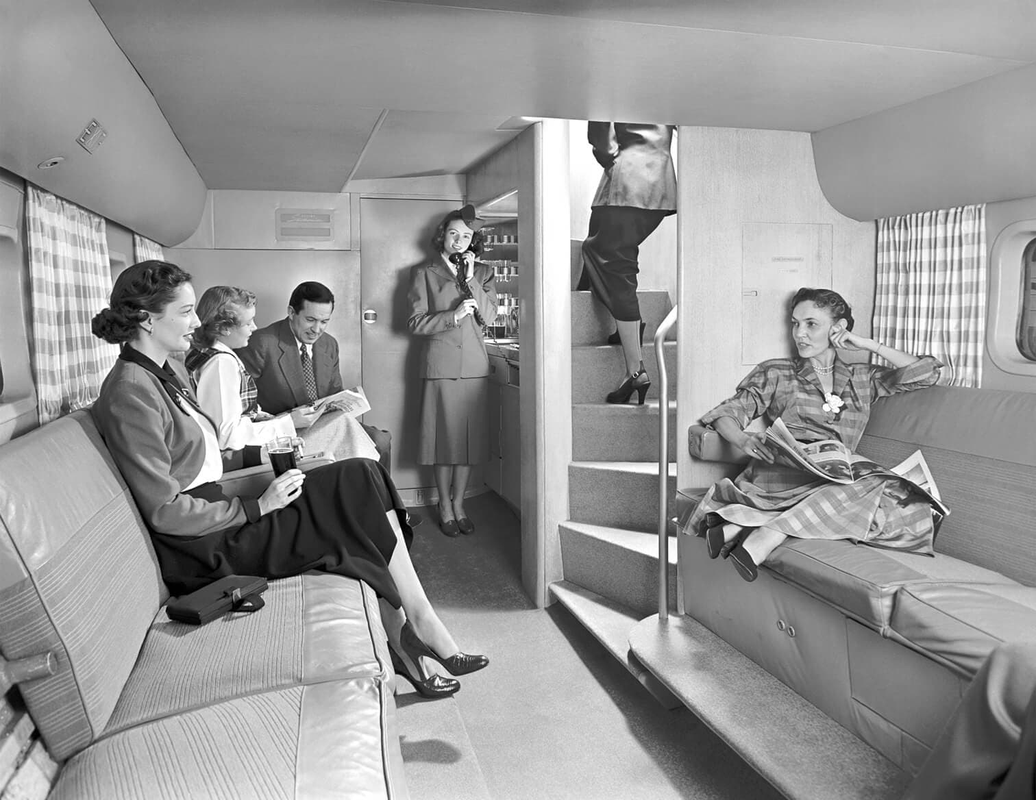 Group of people sitting in lower deck of Boeing Stratocruiser