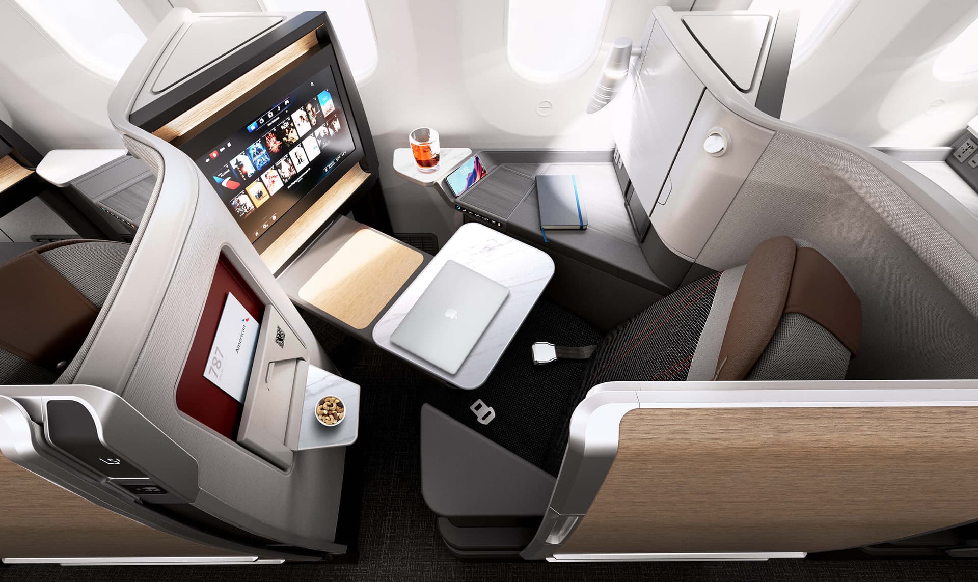 American Airlines B787 Dreamliner Business Class seat with tray table down and a selection of movies on seat back screen