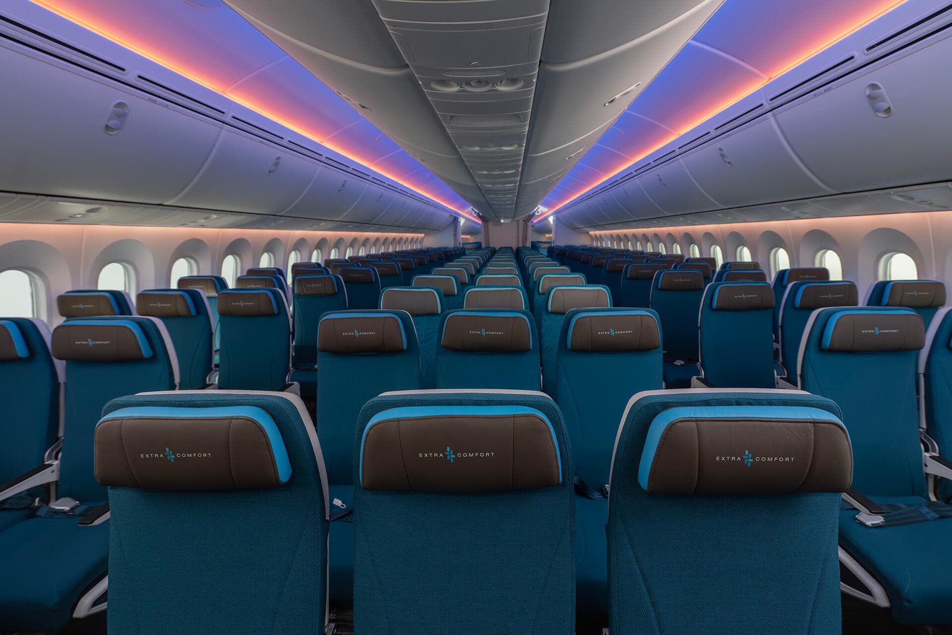 Hawaiian Airlines 787 Extra Comfort Class with blue seating fabric and pink and purple cabin ceiling lighting