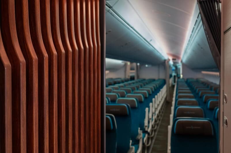 Hawaiian Airlines 787 Economy Class Cabin with turquoise blue seating and overhead cabin lighting