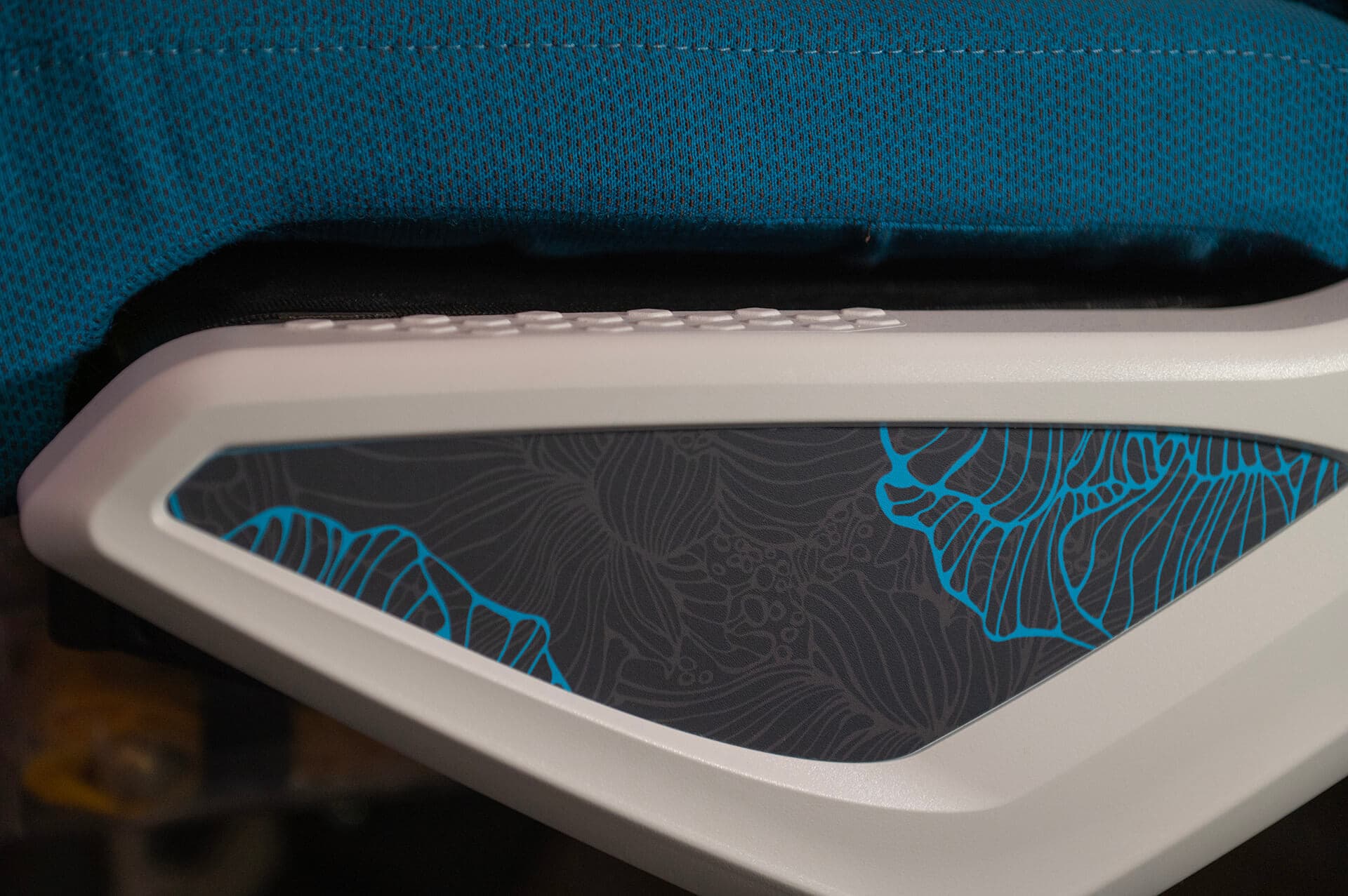 Hawaiian Airlines seat with side detail showing floral patterns in blue tone fabric