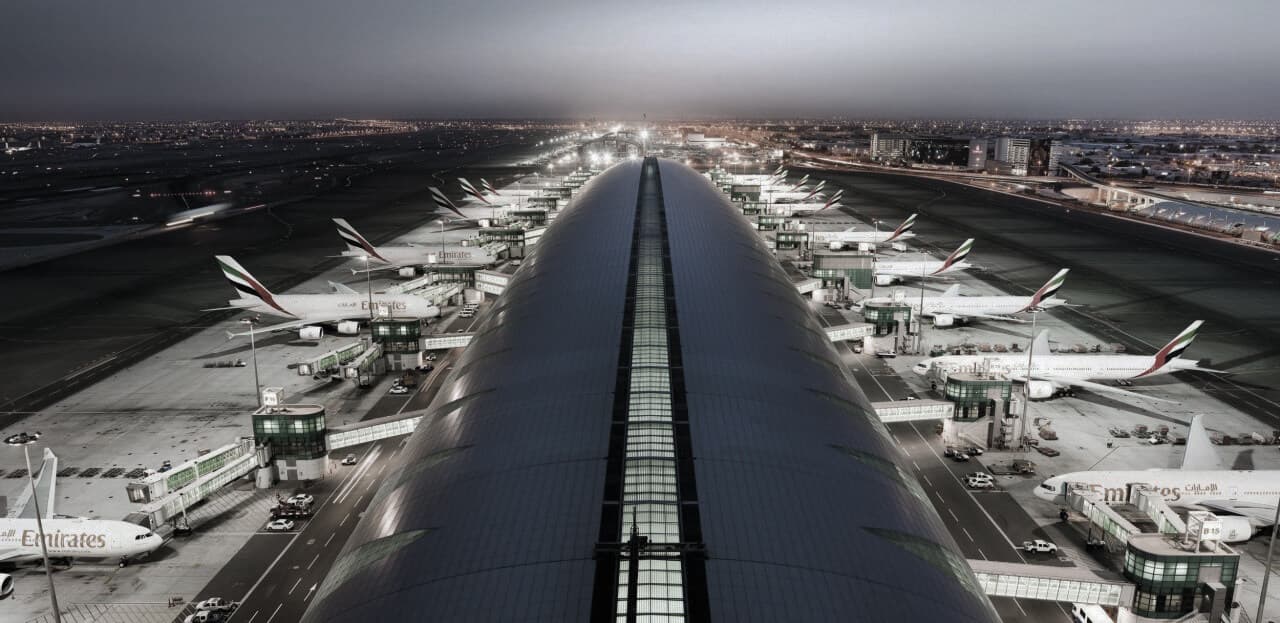 Dubai Airport during the day with Emirates Airline airplanes lined up