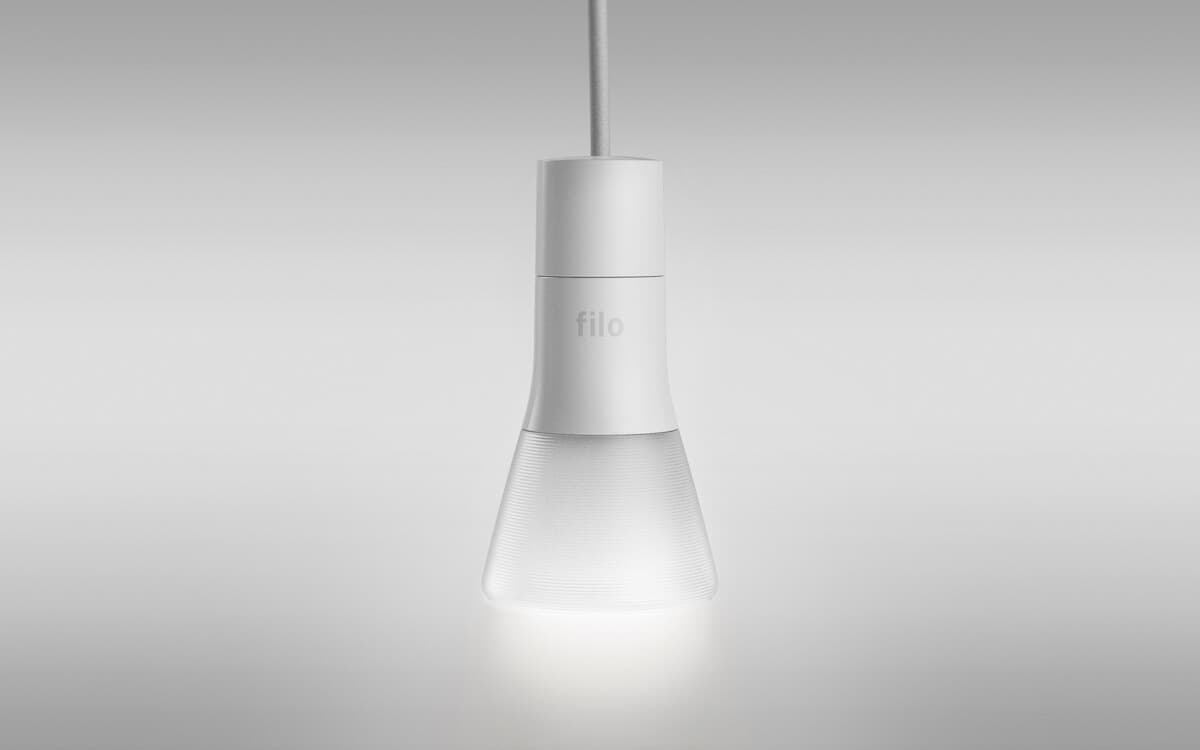 Filo smart lightbulb hanging in front of white background