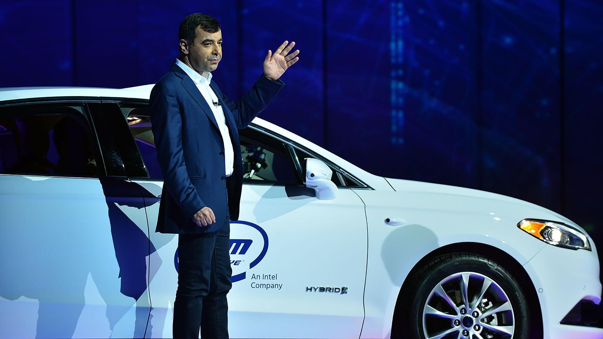 Man showing Intel's autonomous car at the CES tradeshow