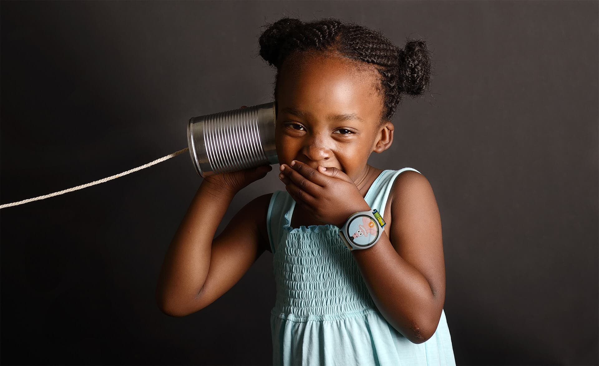 Girl wearing NickWatch playing telephone