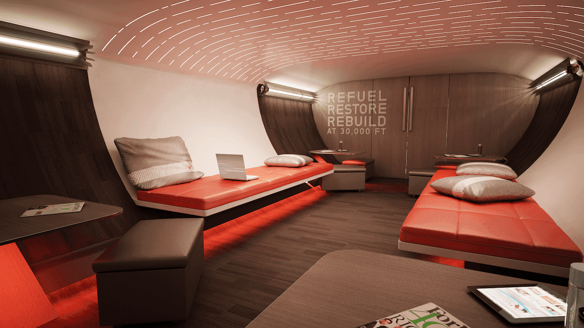 Lower lounge in airplane with comfortable bench seating and red and beige colors, materials, and finishes
