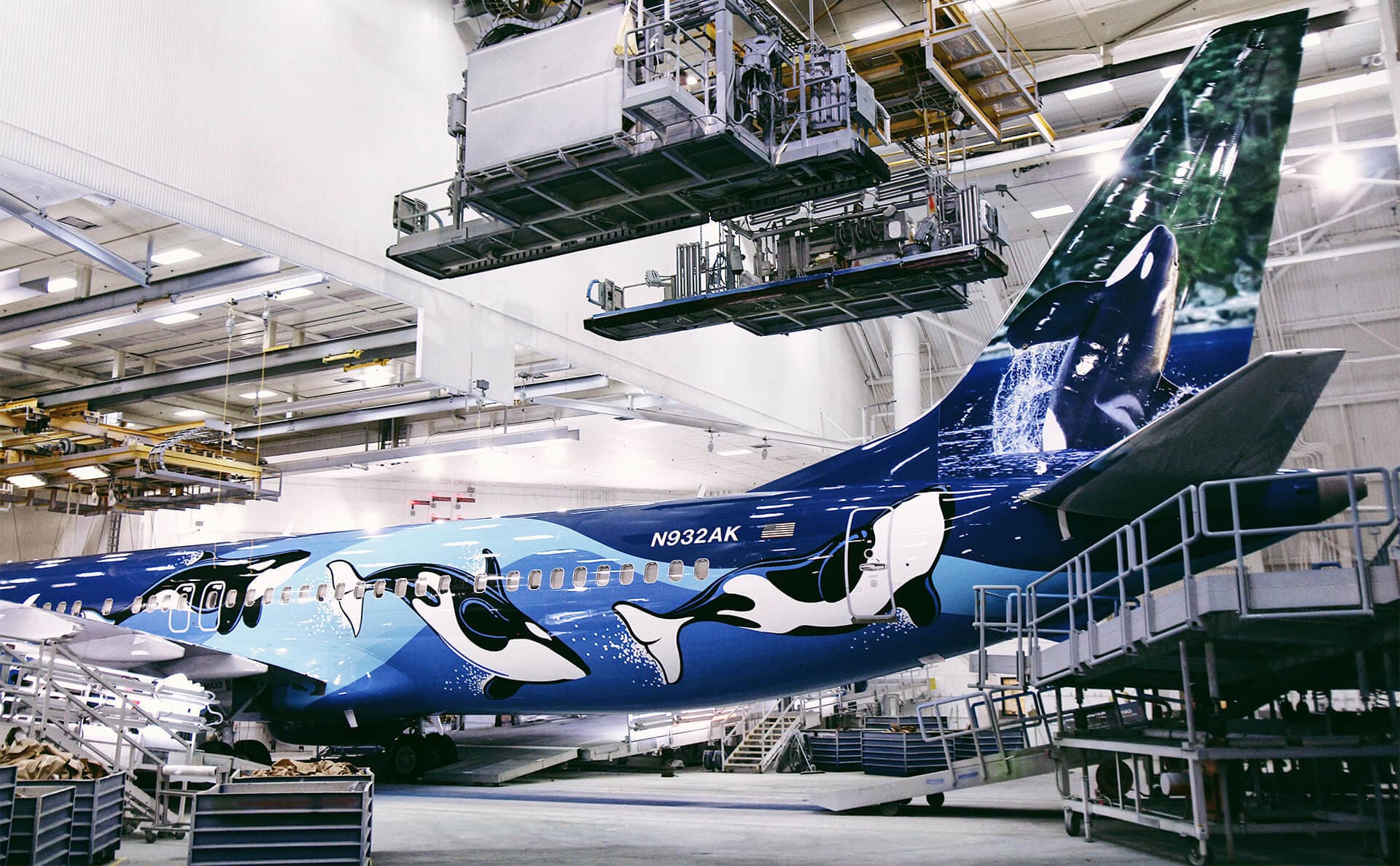 Alaska Airlines 737 airplane with orca livery design in paint hanger