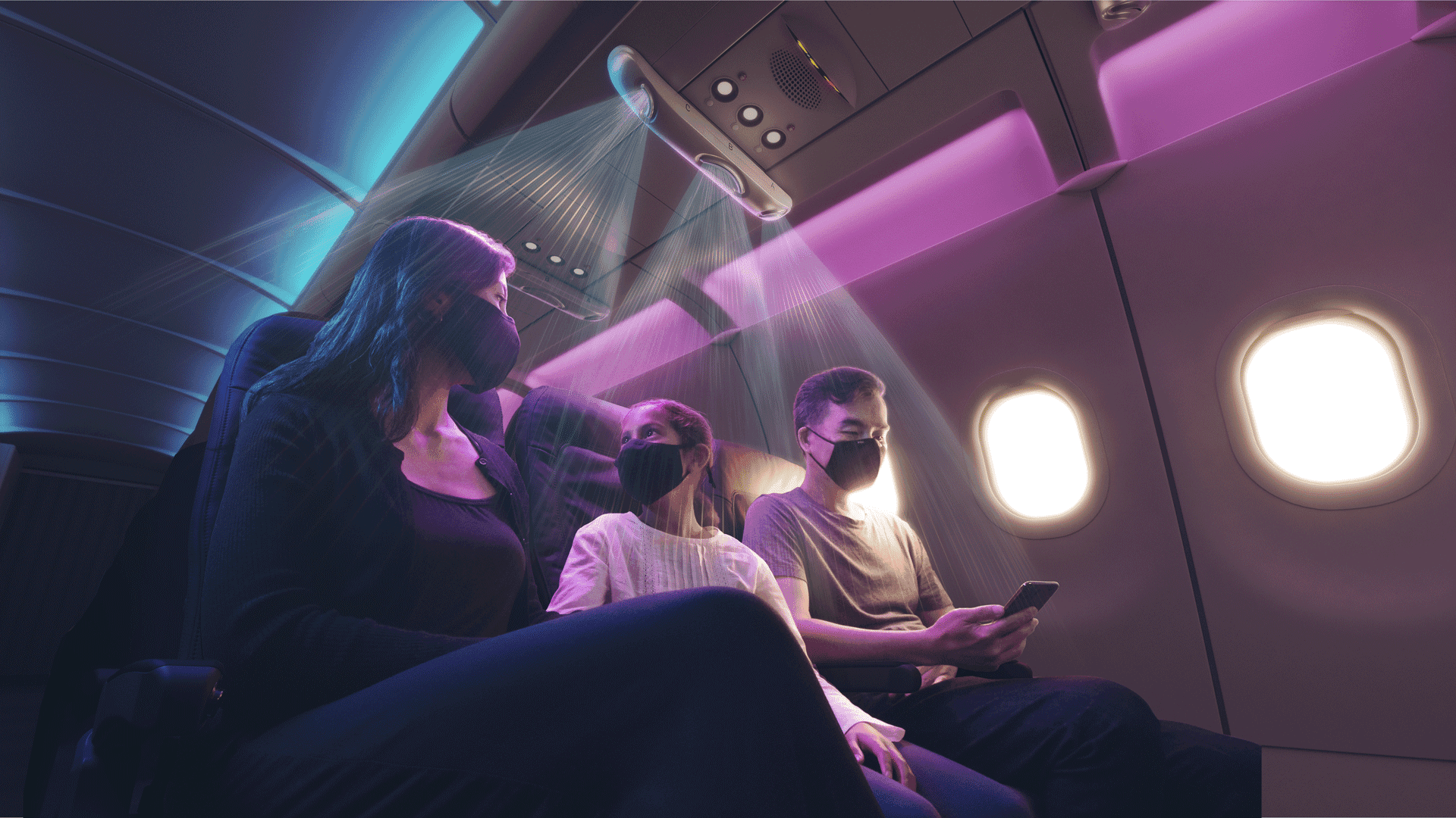 Three passengers seated on airplane under the AirShield cabin-air safety device