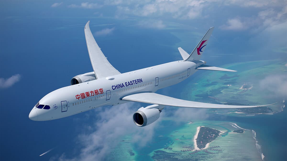 China Eastern airplane flying through the sky over blue water