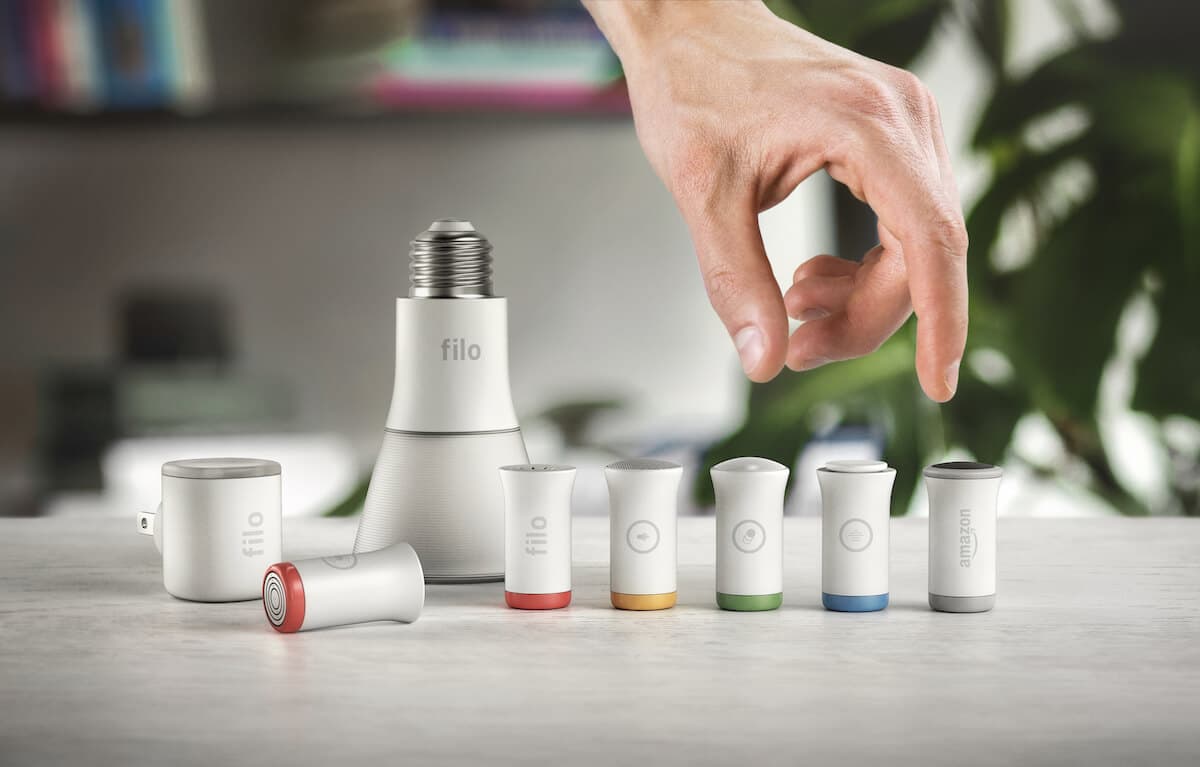 Hand reaching to pick up a Filo smart light bulb component