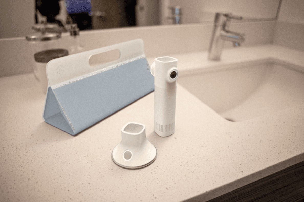 Remote healthcare devices sitting on a white counter in a bathroom