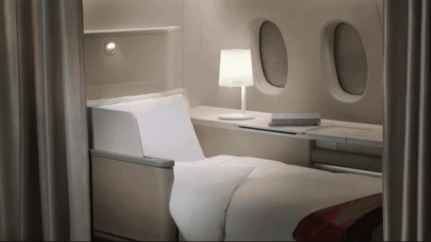 First class cabin with lay flat bed and lamp