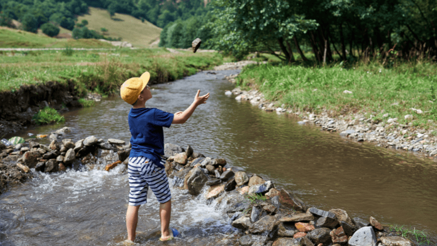 Kid playing in a stream