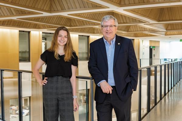 Katherine "Kat" Lasonde '23 and Professor Eric Fossum stand together in an open walkway of the Thayer ECSC building.