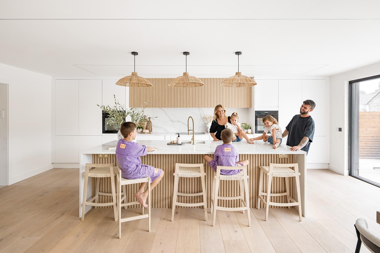 Family in kitchen with quartz worktops