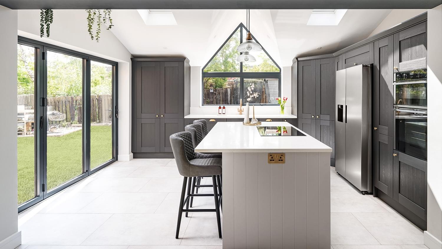 Grey kitchen cabinets with marble-like quartz