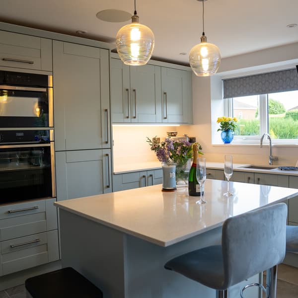 James Humm Minerox Arctic Starburst full kitchen wide shot worktop island flowers champagne window cill