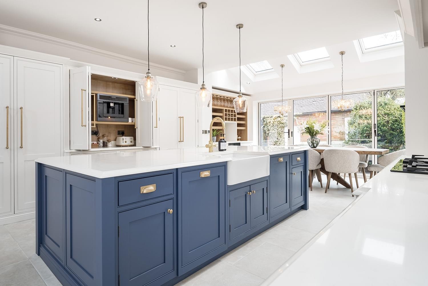 Two-tone kitchen with white quartz worktops and belfast sink