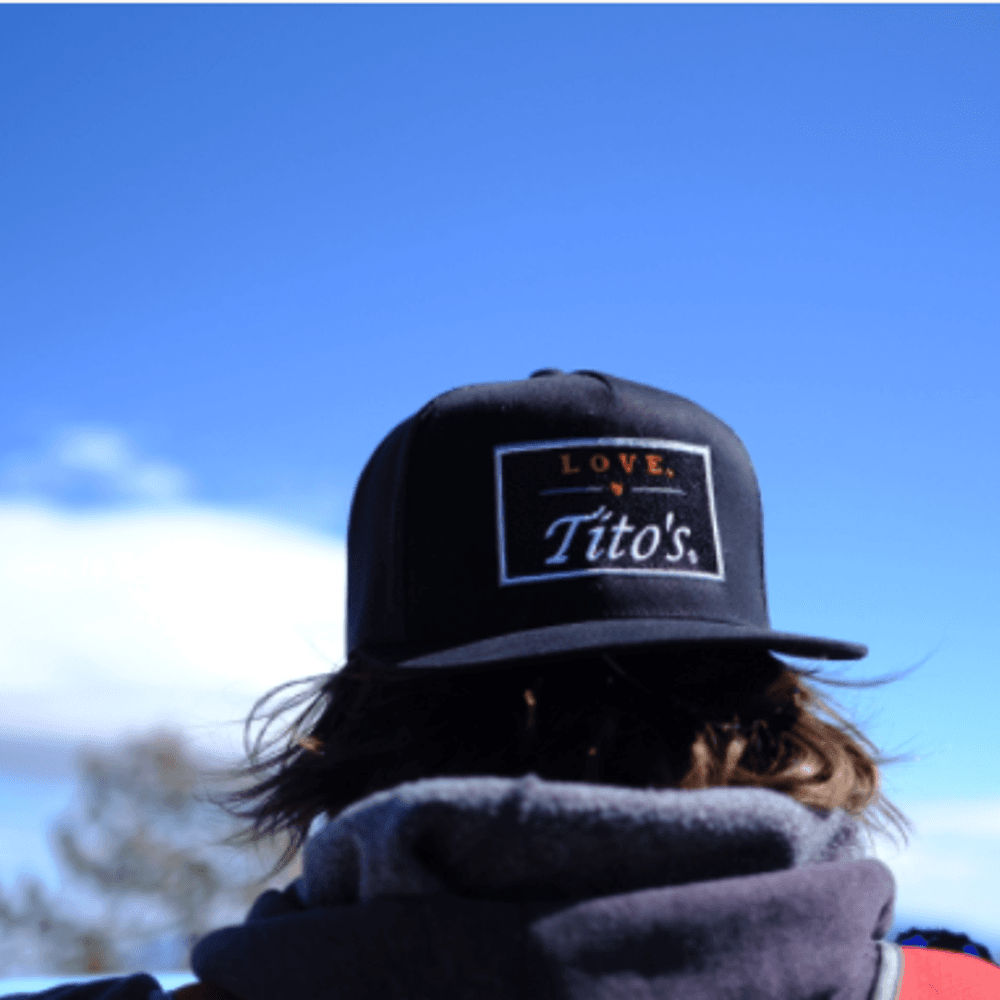 Man wearing Love, Tito's hat backwards