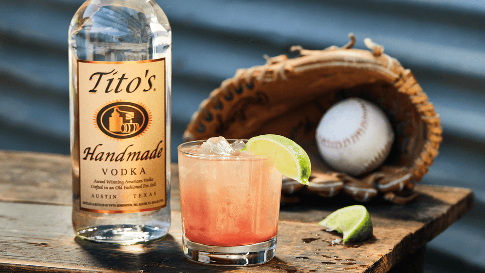 Tito's Guava Agua Fesca with a baseball, baseball glove, and bottle of Tito's Handmade Vodka