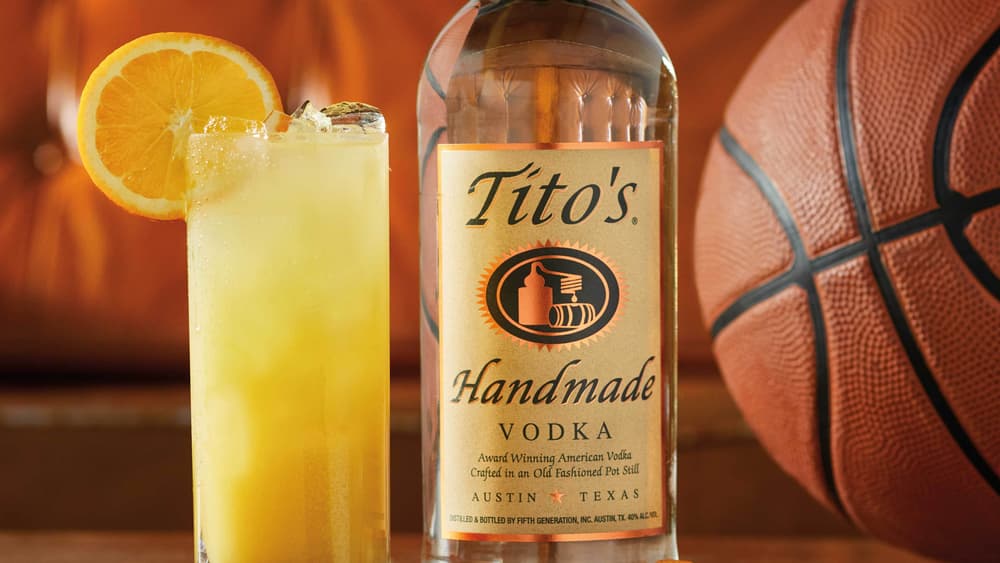 Tito's Orange Refresher, a Tito's Handmade Vodka bottle, and a basketball