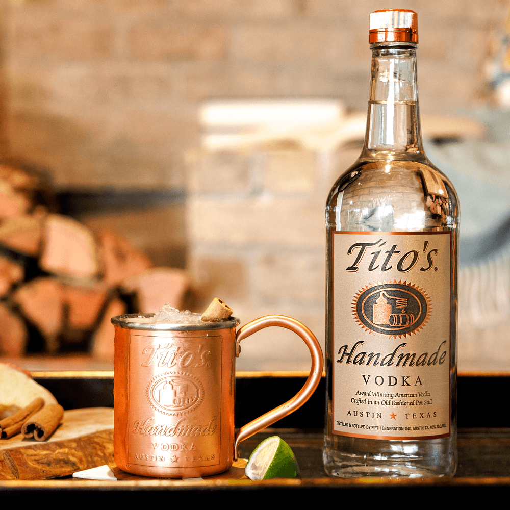Tito's Spiced Cider Mule in Tito's Copper Mug with Tito's Handmade Vodka bottle