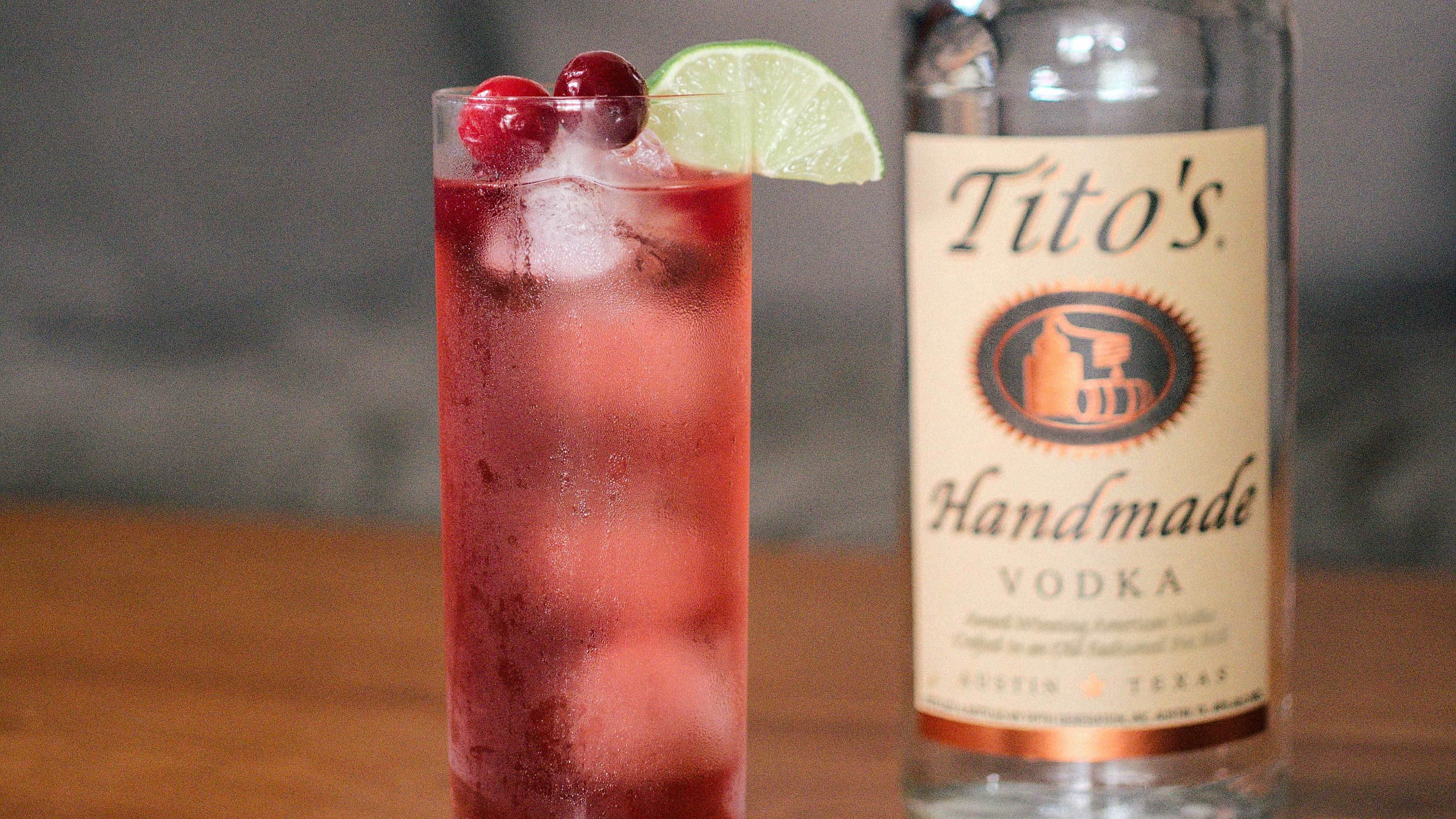 Tito's & Cranberry garnished with a lime slice and two cranberries