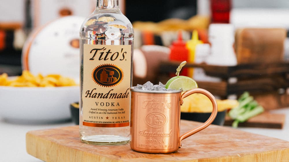 Tito's Handmade Vodka bottle and a Tito's Brewed Mule