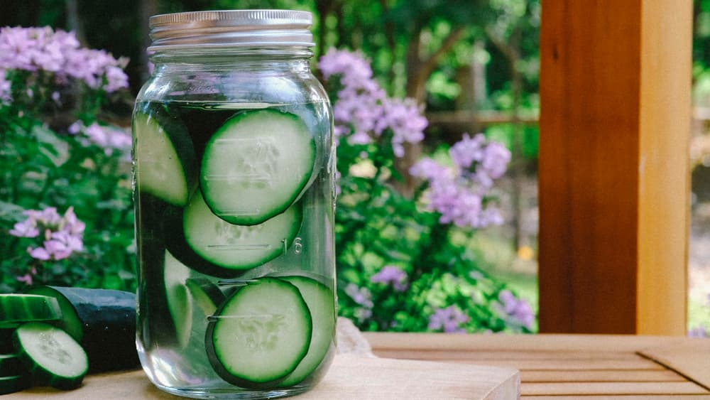 Mason jar filled with Tito's Vodka and cucumbers