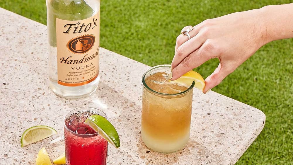 Tito's Lemonade & Tea on a table next to a Tito's Handmade Vodka bottle