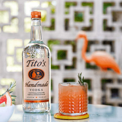 Tito's Greyhound in rocks glass next to Tito's Handmade Vodka bottle