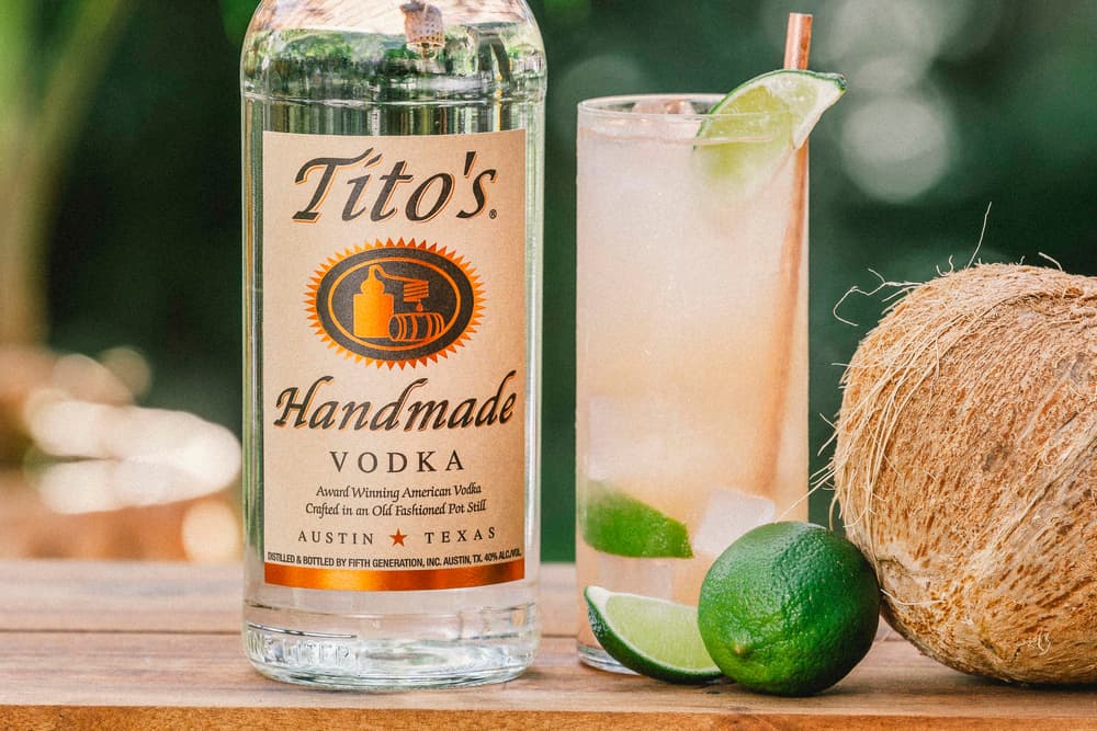 Tito's Guava Water cocktail next to a Tito's Vodka bottle