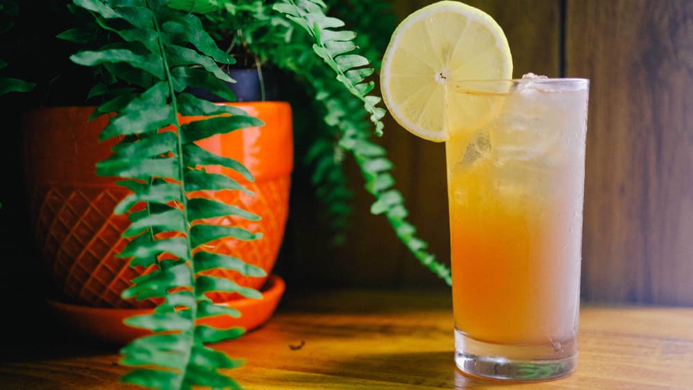 Tito's Halftime in a tall glass garnished with a lemon wheel