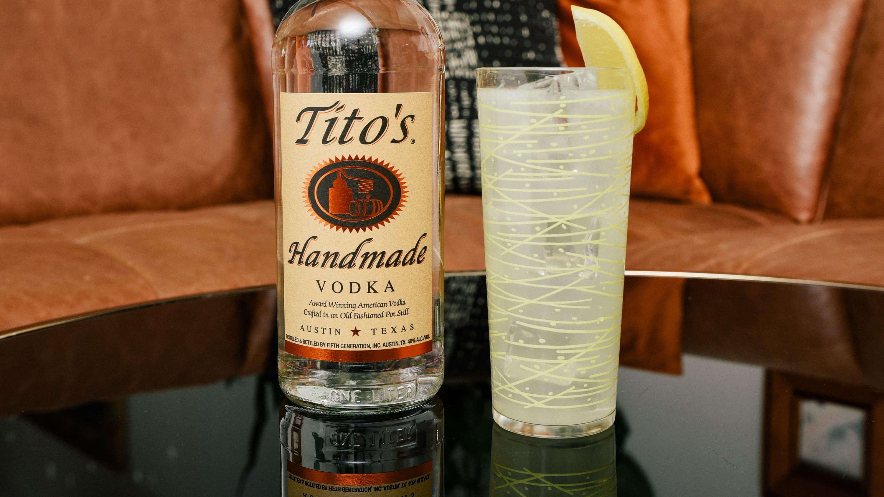 Tito's bottle next to Tito's Lemonade a tall class