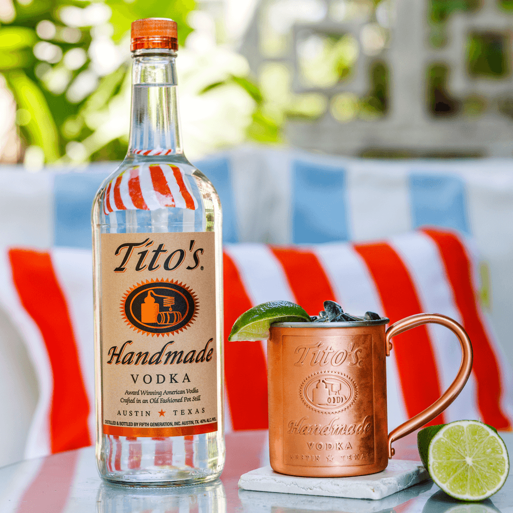 Tito's American Mule in a Tito's Copper Mug next to a Tito's Handmade Vodka bottle