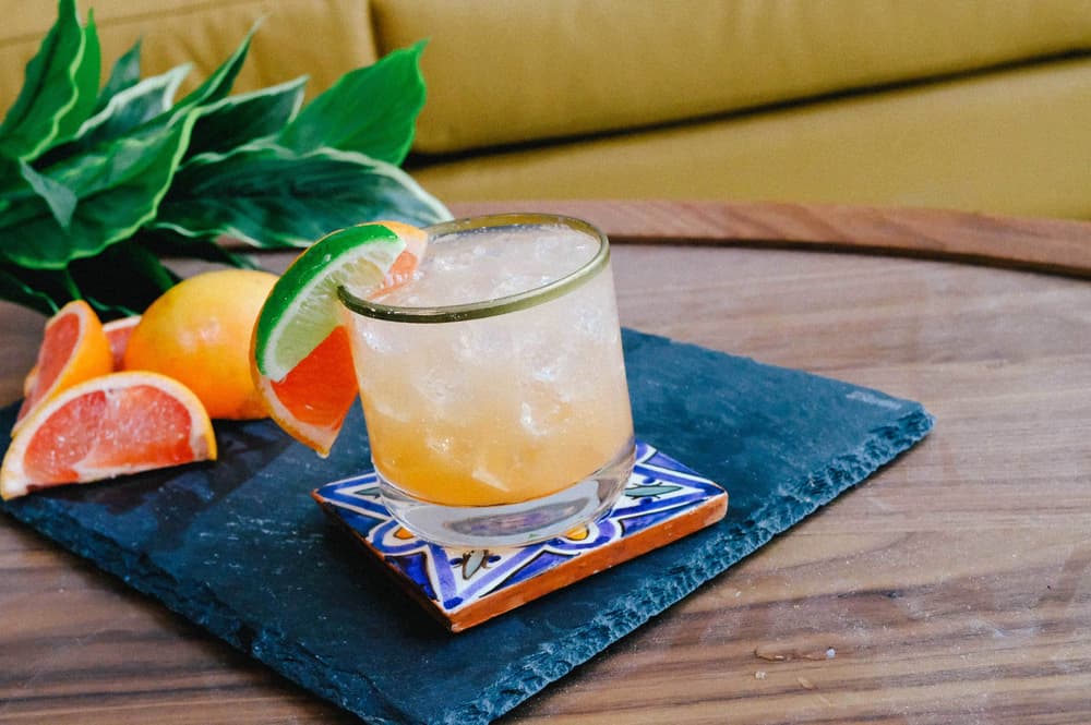 Tito's Paloma garnished with a lime and grapefruit wedge