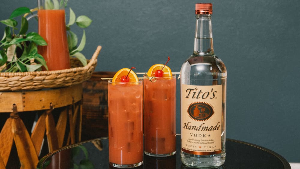 Two Tito's Punch cocktails and a Tito's Handmade Vodka bottle