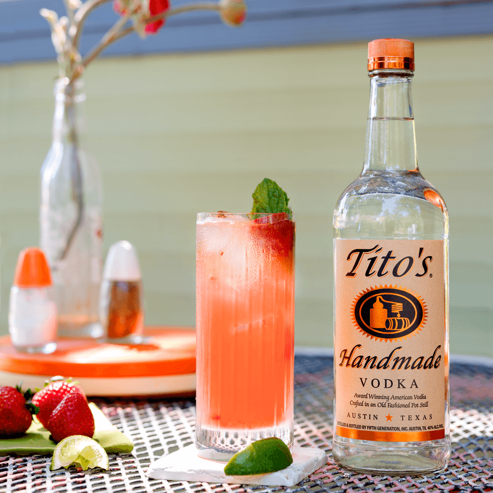 Tito's Strawberry Motito and Tito's Handmade Vodka bottle on a table