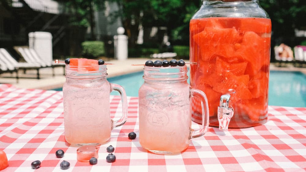 Titos Summertime Sparkler in mason jars garnished with watermelon and blueberries