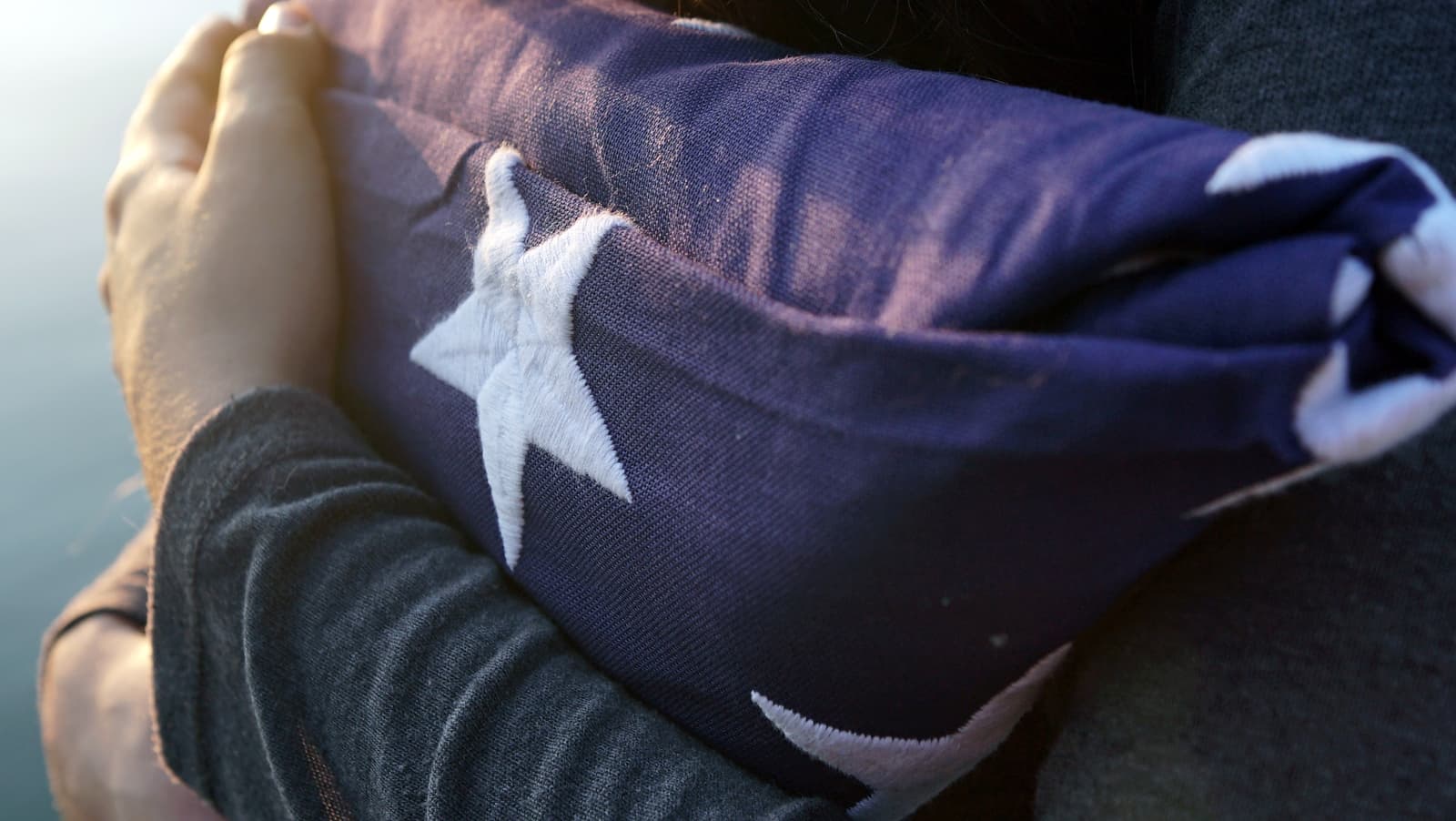 Folds of Honor Volunteer Holding American Flag